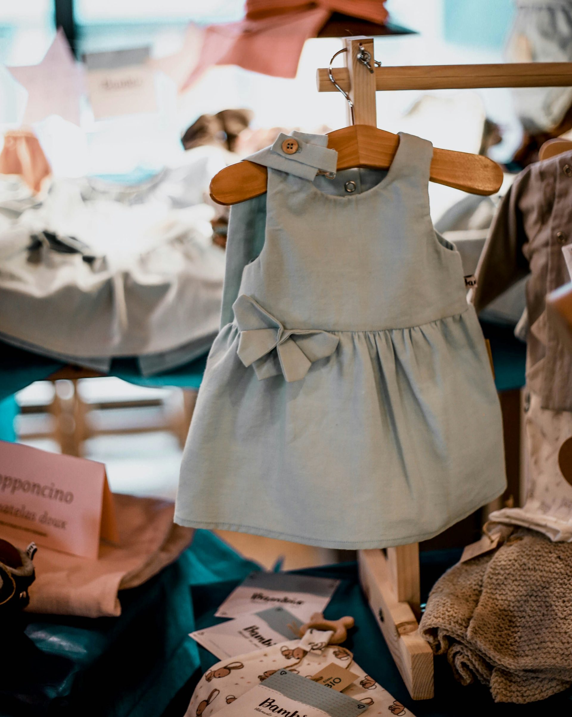 blue and brown dress on brown wooden clothes hanger